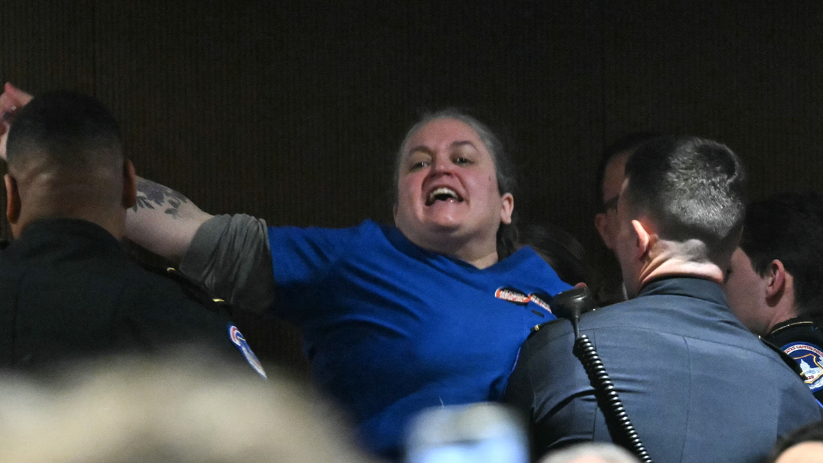 RFK protester being escorted out