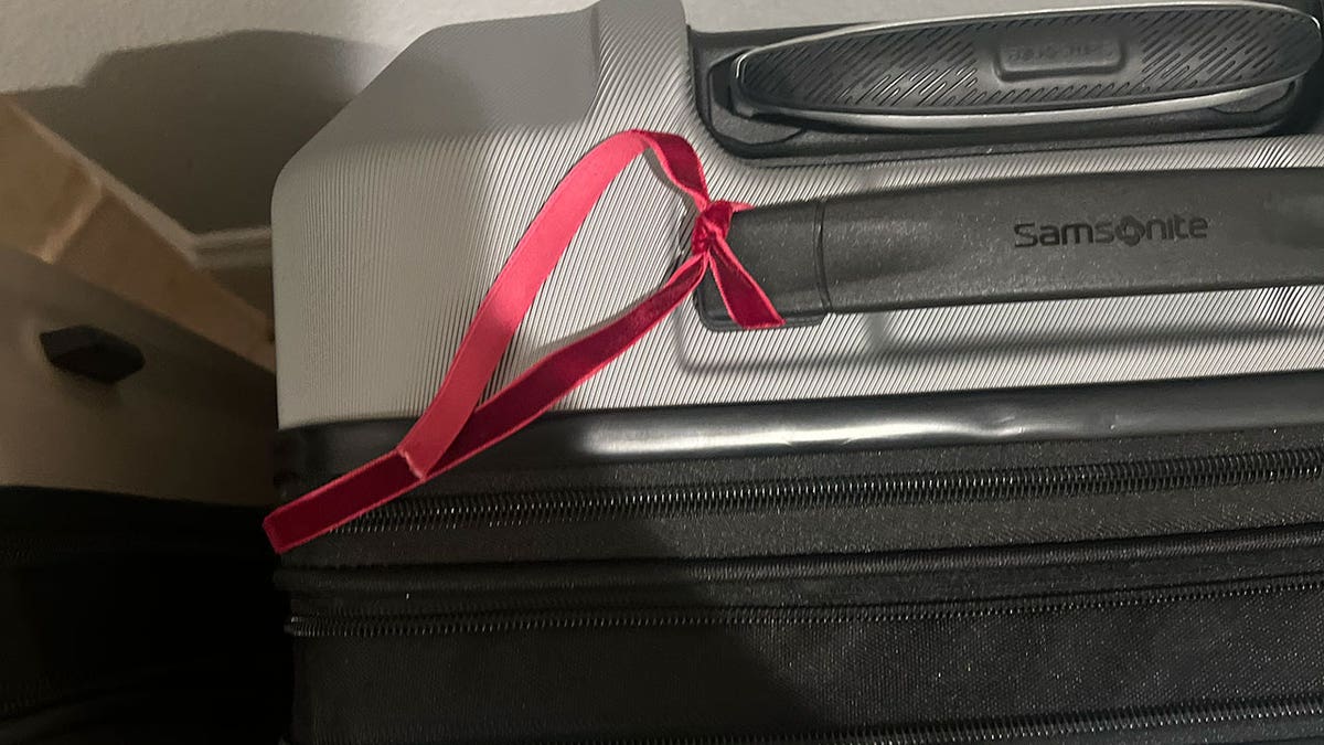 red ribbon on suitcase