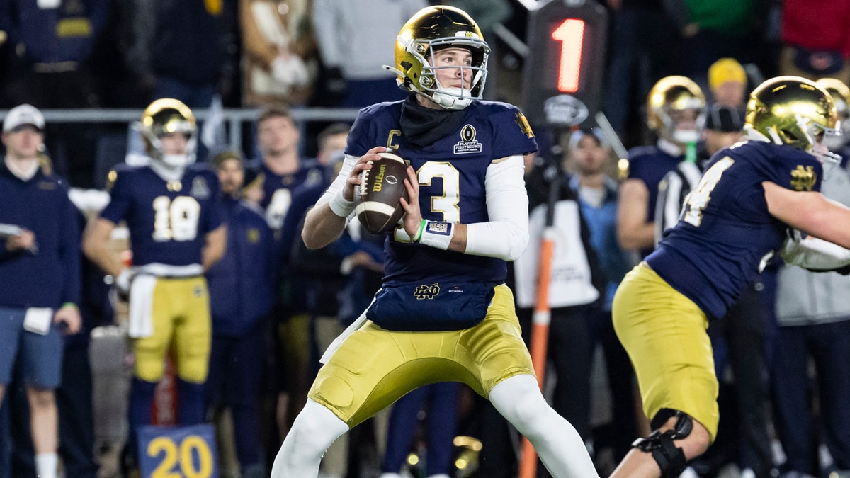 Notre Dame quarterback Riley Leonard runs back to pass the ball against Indiana in a home playoff game.