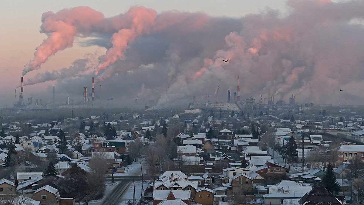 Steam rises from the smokestacks of Gazprom Neft's oil refinery in Omsk