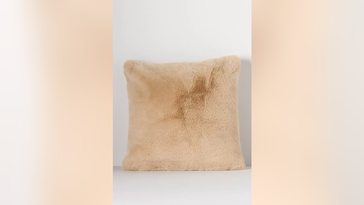 A faux fur pillow is comfortable and stylish. 