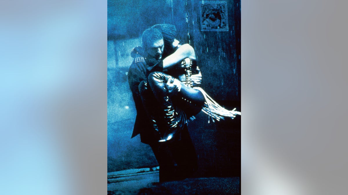 Kevin Costner holding on to Whitney Houston in a scene from The Bodyguard.