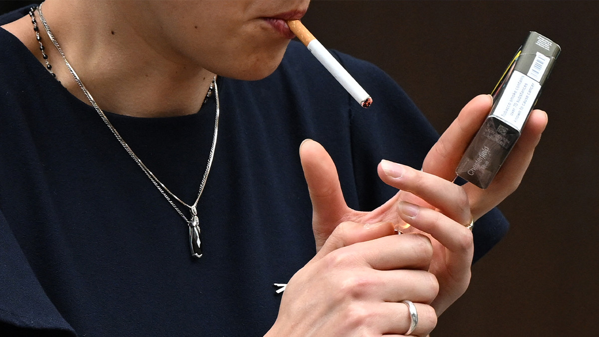 Photo gallery of a woman lighting a cigarette