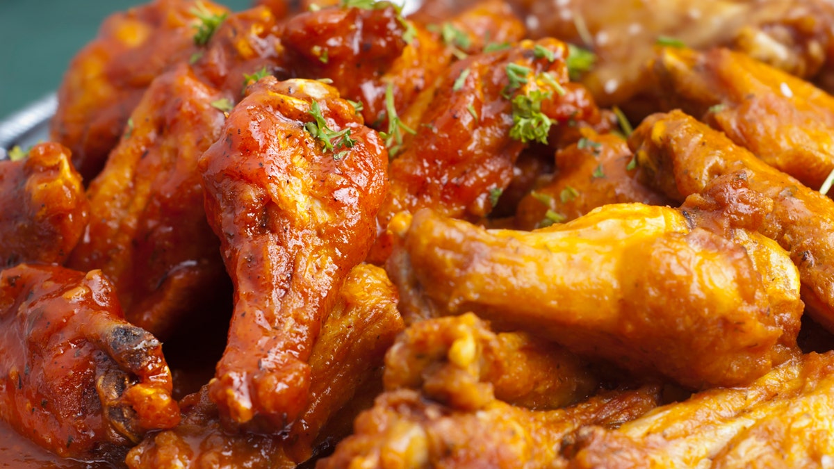 A close look at the hot chicken wings on a plate.