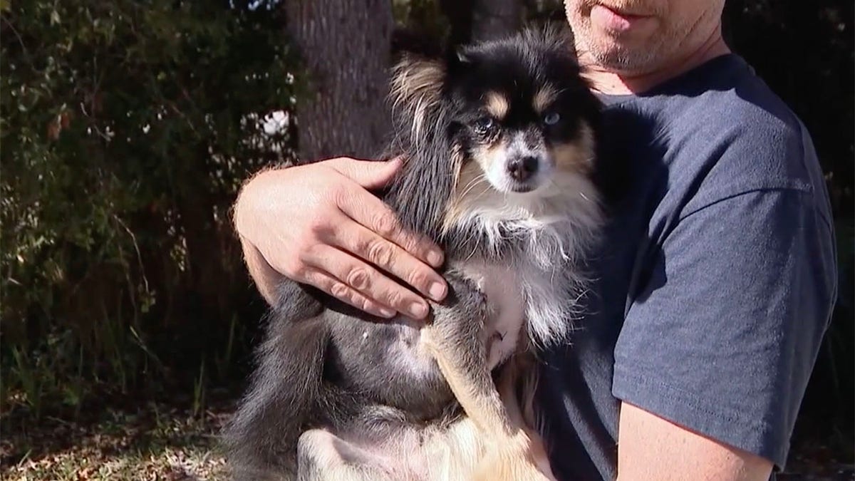 Blake Sprout holds his dog Karen