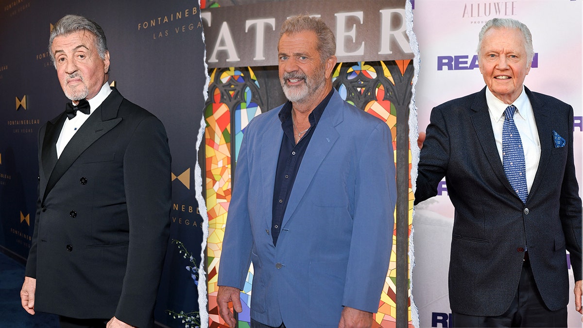 Sylvester Stallone in a classic black tuxedo looks serious as he looks directly into the camera on the separate carpet. Mel Gibson smiling in a blue suit and black shirt on the split carpet Jon Voight in a dark navy suit with a blue tie with American flags on it smiling on the carpet and extending his hand