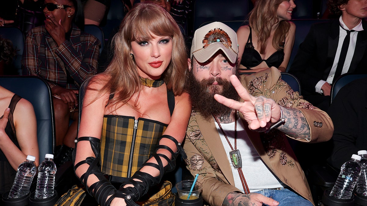 Taylor Swift and Post Malone pose at an awards show