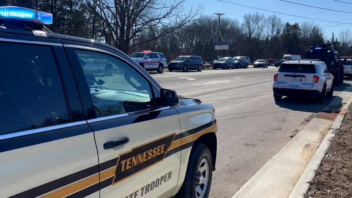 Police cars line the street outside Antioch High School.