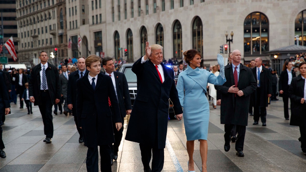 Donald and Melania Trump with Barron walking down Pennsylvania Avenue.