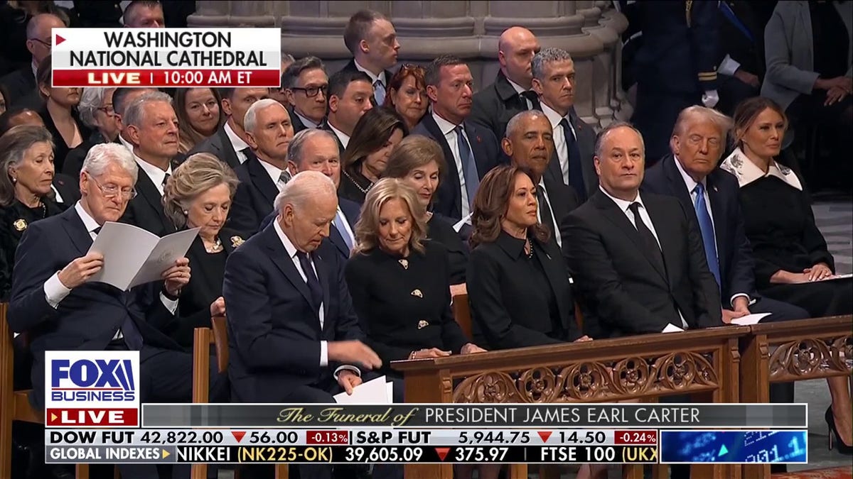 Joe Biden is in the front row, with former presidents behind him