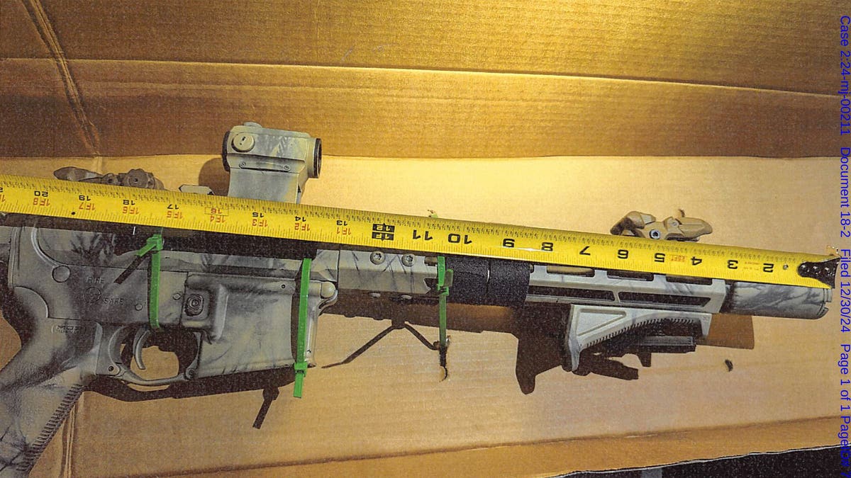 A rifle that federal agents seized when they arrested Brad Spafford in December 2024 is measured.