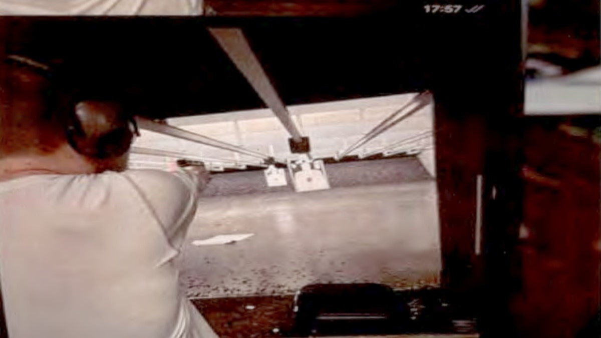 Alexander Justin White firing a gun at a range in July 2024