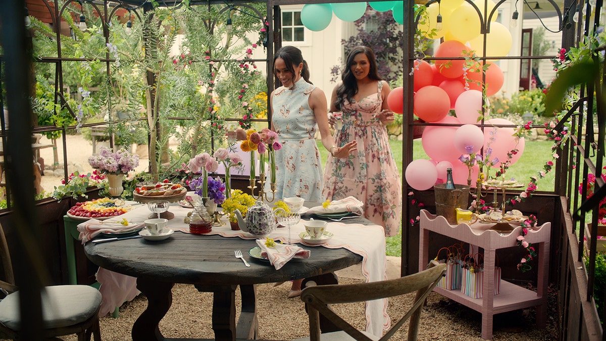 Meghan Markle and Mindy Kaling walk through the outdoor nursery