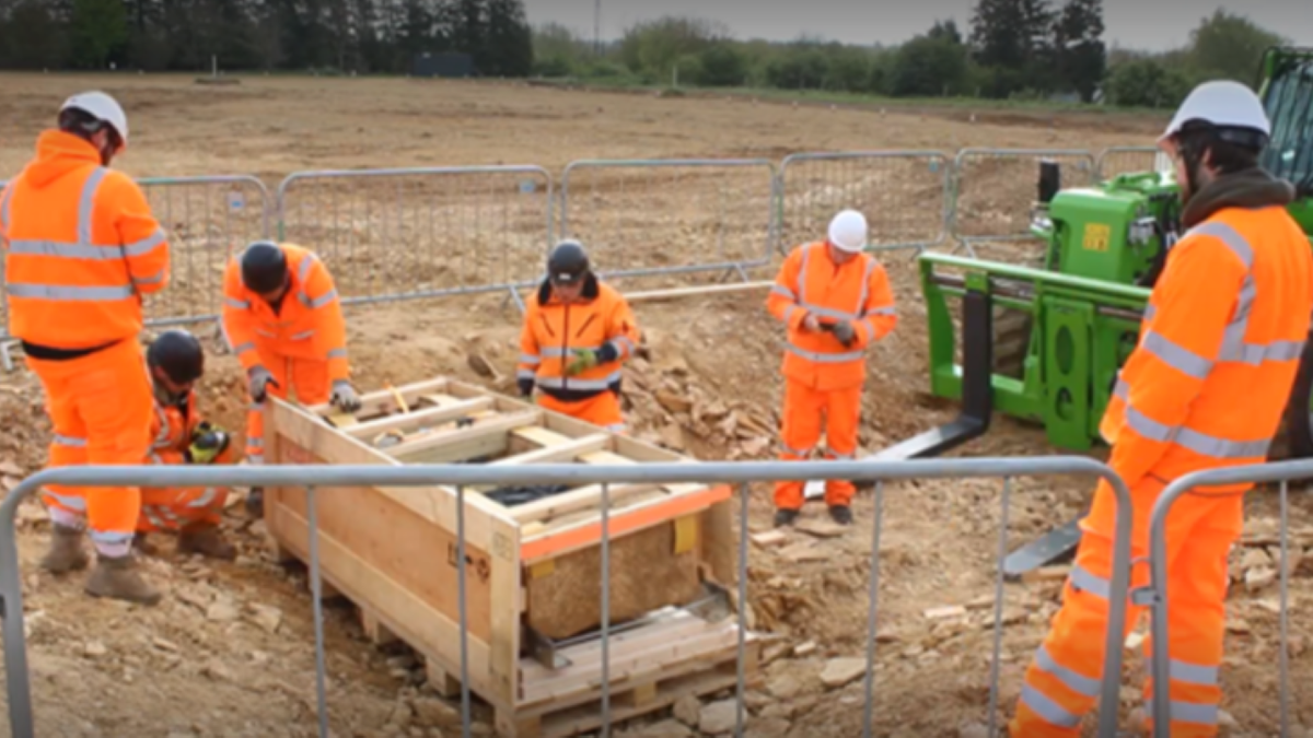 Highway workers near coffin