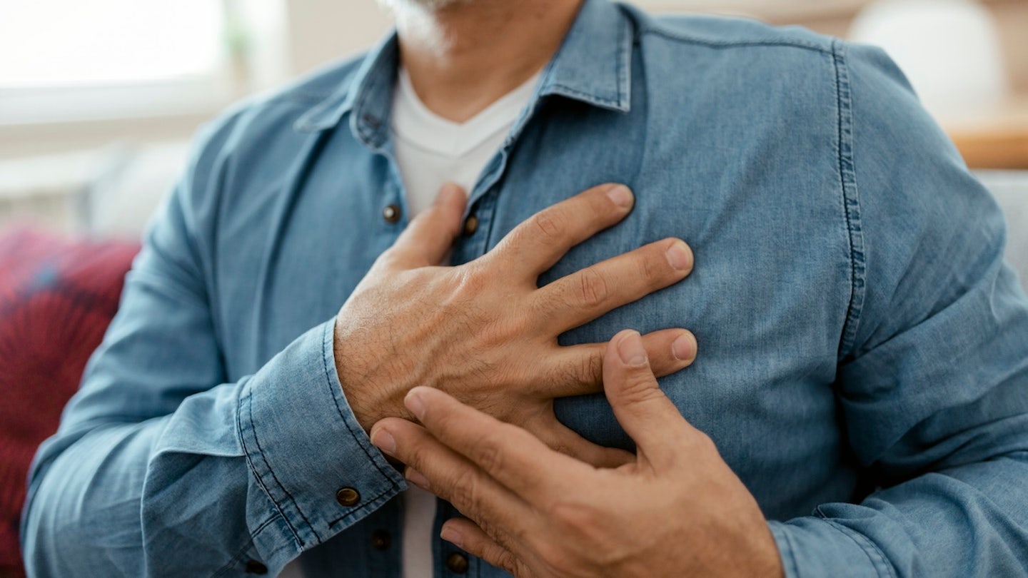 man holding chest