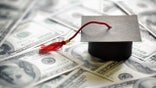 Graduation cap on a pile of money