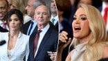 Lauren Sánchez in a white blazer and busty lace white bra/top stands beside Jeff Bezos in a dark suit and dark red tie split Carrie Underwood sings into the microphone and looks out to the audience the inauguration