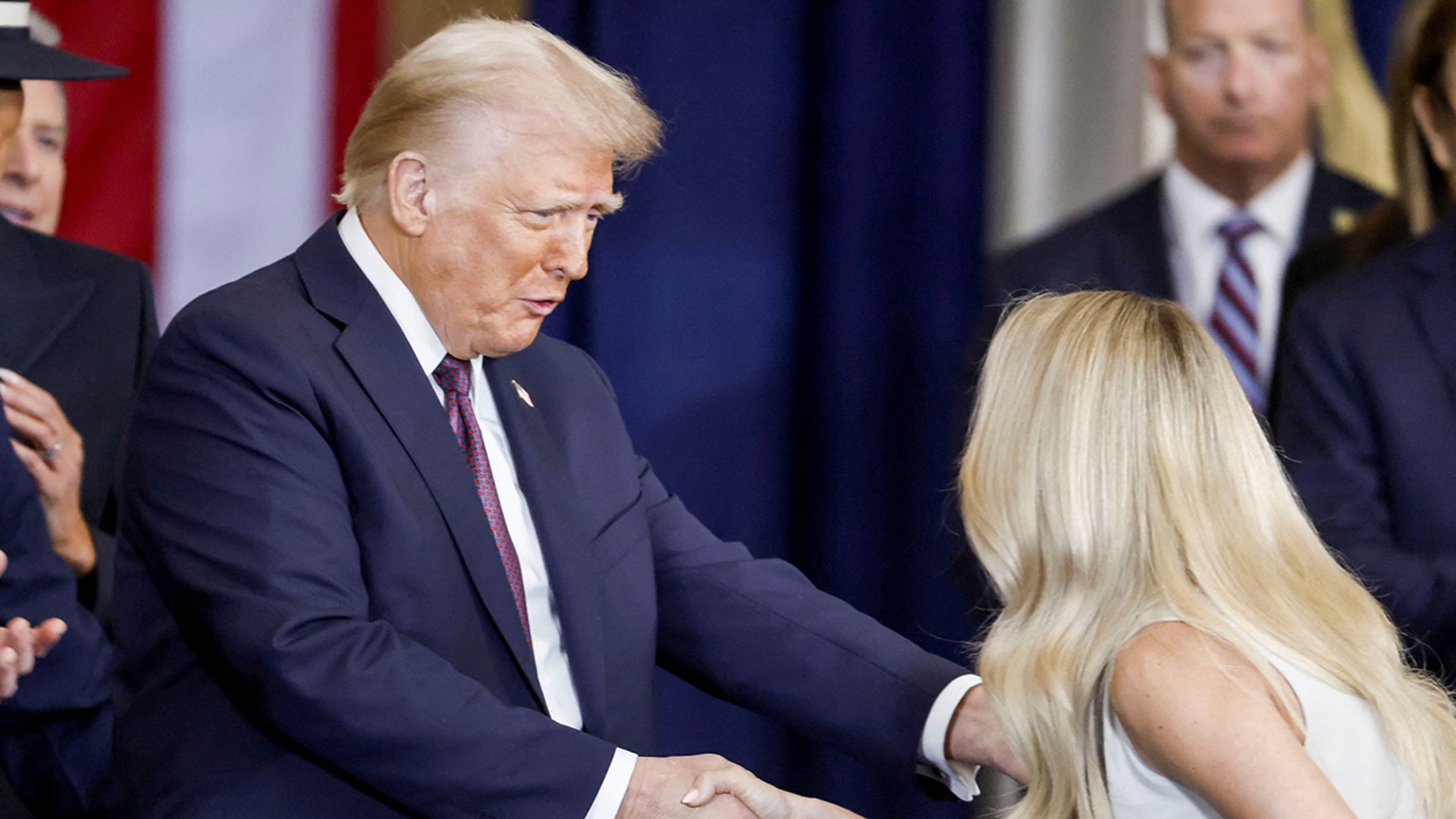 Country singerCarrie Underwood shakes hands US President Donald Trump after performing ‘America the Beautiful’ during Trump’s inauguration ceremony