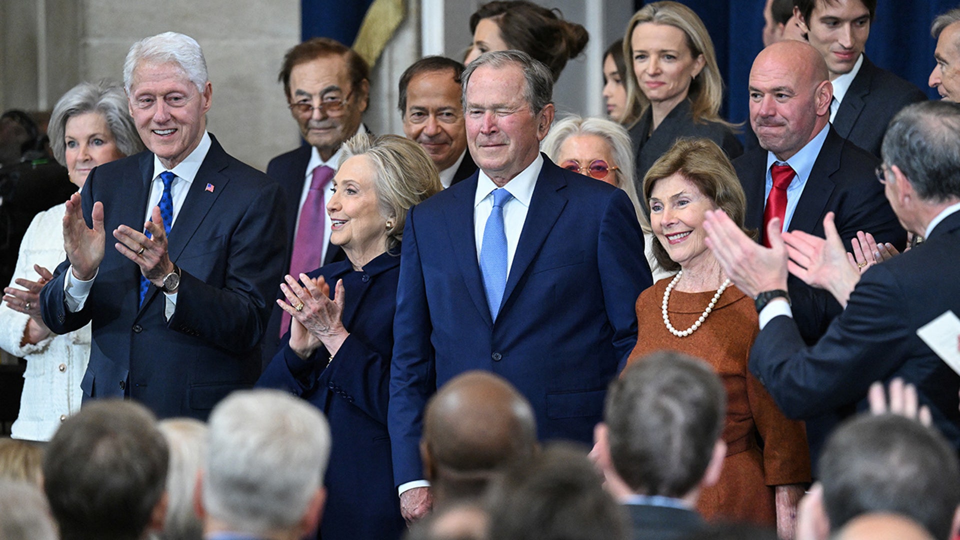 Former US President George W. Bush winks as he arrives for the inauguration ceremony before Donald Trump is sworn in