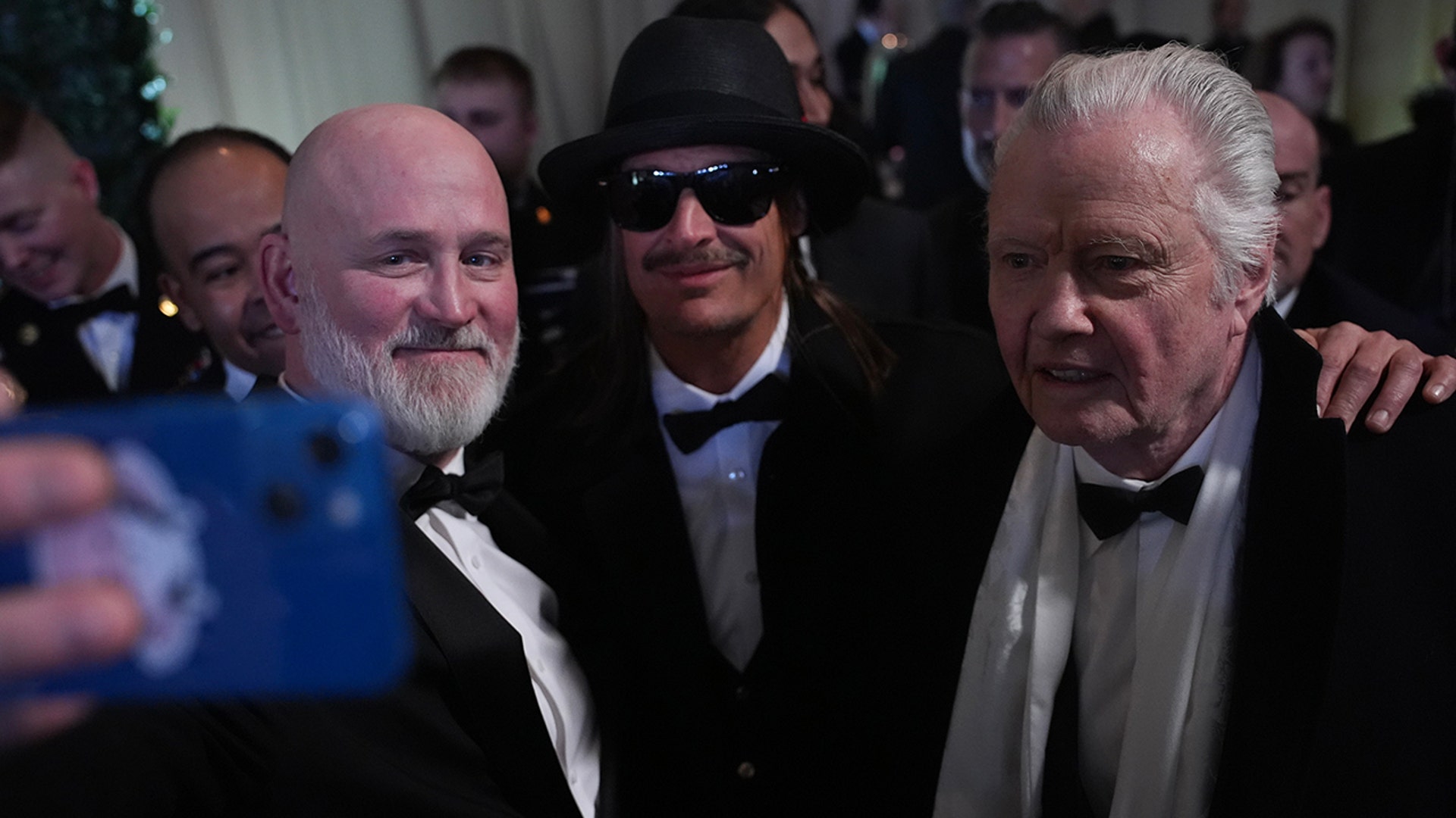 Jon Voight and Kid Rock pose with a fan while at the Commander in Chief Ball on President Donald Trump's inauguration day.