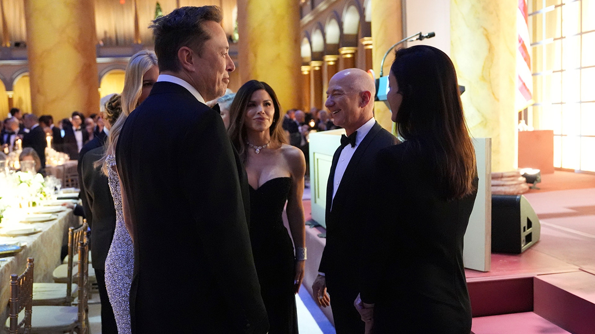 Elon Musk speaks in a group with Ivanka Trump, Lauren Sanchez, Jeff Bezos and Shivon Zillis at the National Building Museum