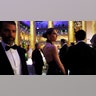 Donald Trump Jr. walking off camera in a classic tuxedo and Bettina Anderson in a halter dress at a dinner ahead of the inauguration for President-elect Donald Trump