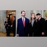 Donald Trump Jr. in a blue suit and red tie walks into the Rotunda with his daughter Kai Trump in a black jacket