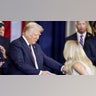 Country singer Carrie Underwood shakes hands US President Donald Trump after performing ‘America the Beautiful’ during Trump’s inauguration ceremony