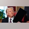 Donald Trump takes part in a signing ceremony after his inauguration