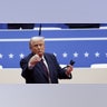 Donald Trump throws a pen during a rally on the inauguration day