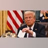 Donald Trump in the oval office holds a note from Joe Biden