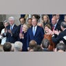 Former US President George W. Bush winks as he arrives for the inauguration ceremony before Donald Trump is sworn in