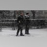 Secret Service officers stand during a snowstorm outside of the White House as they guard the departure of U.S. President-elect Donald Trump to a rally
