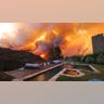 Pool seen with blazing Palisades fire approaching