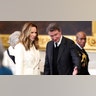 Janet Jones in a cream jacket stands beside husband Wayne Gretzky in the Capitol