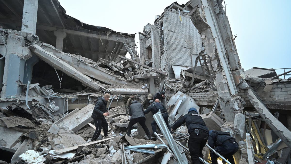 Russian missile strike on Ukraine: officers search through rubble