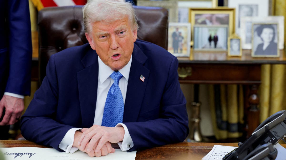 Trump speaks to reporters at the White House while signing executive orders 