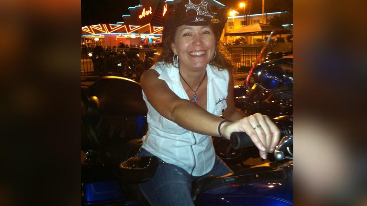 Nicole Munda on top of a Harley motorcycle