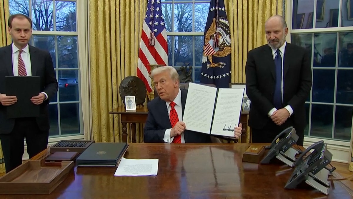 Trump holds up signed executive order