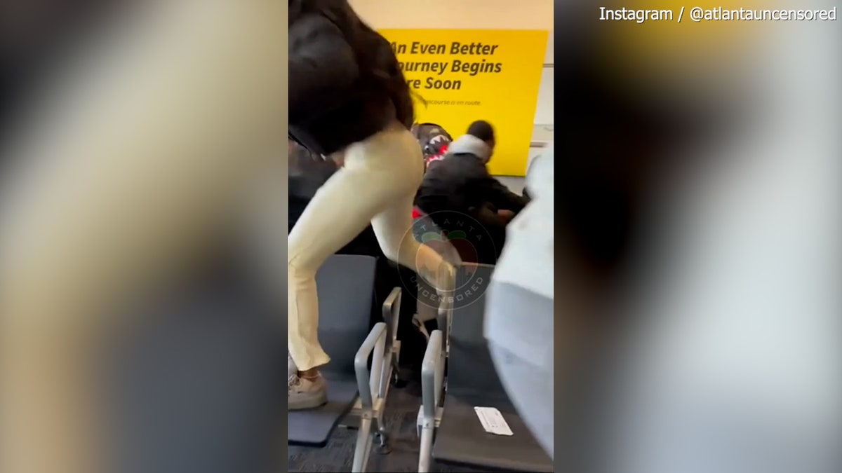 Woman climbing over seats at airport terminal