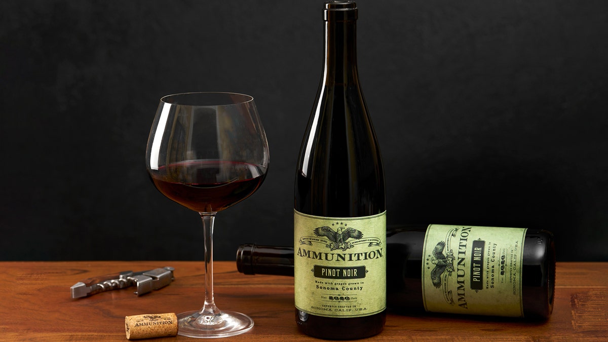 A solid  of reddish  vino  is disposable   connected  a array  adjacent  to 2  bottles of Ammunition's pinot noir.