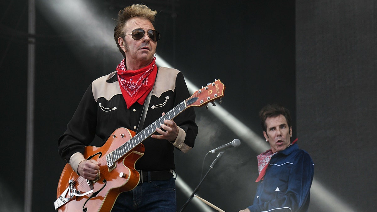 Brian Setzer playing guitar on stage