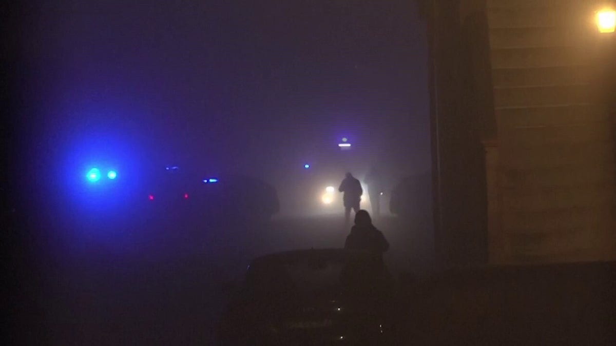 Officials standing in fog