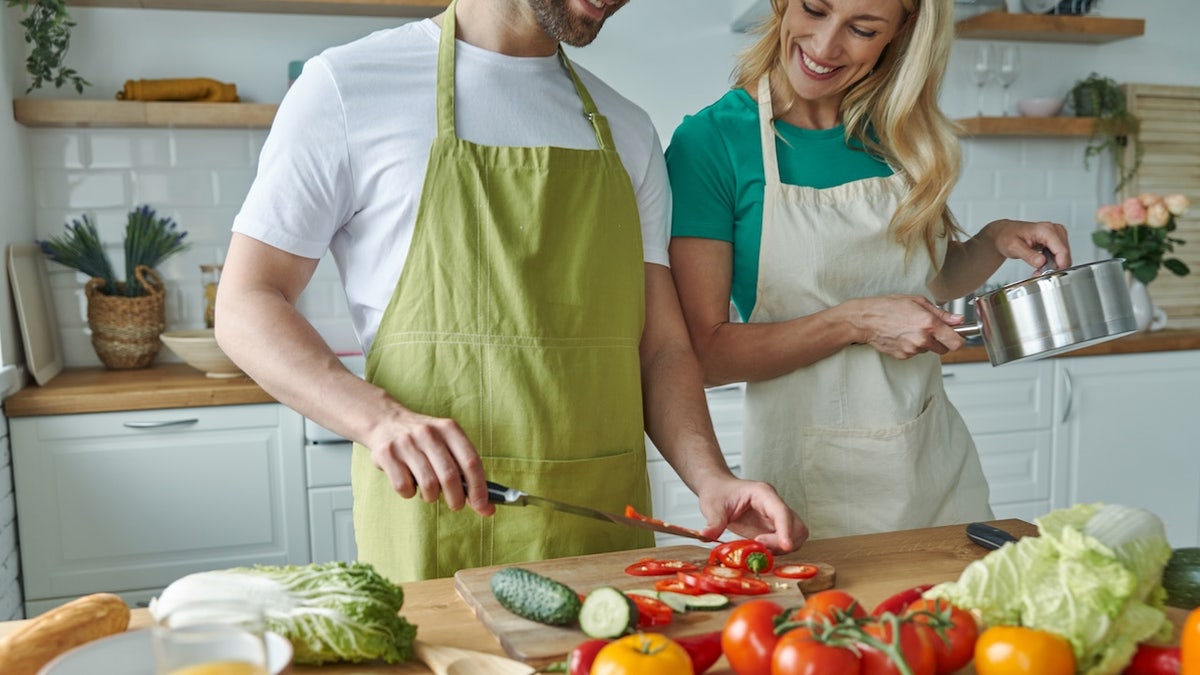 Couple cutting veggies