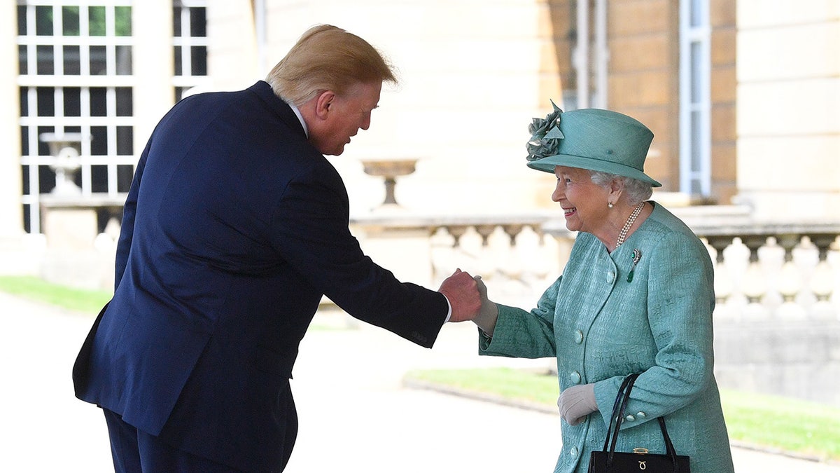 President Trump sharing a smiling Queen Elizabeth II's hand