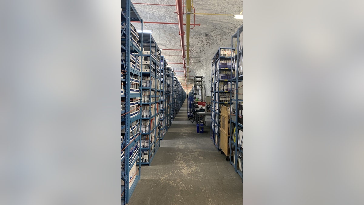 walls lined with filing boxes and shelves