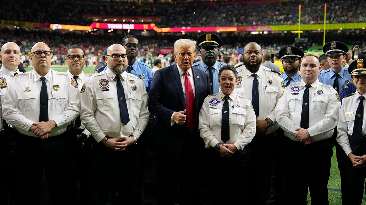 Donald Trump is raised with police officers