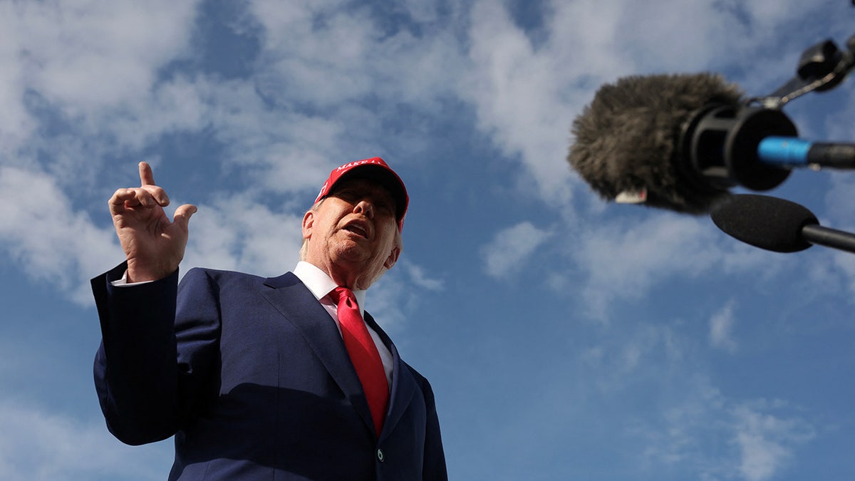 Donald Trump talks to reporters after watching Daytona 500