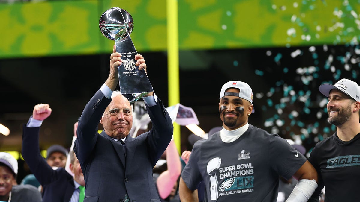 Jeffrey Lurie holds a Lombardy trophy