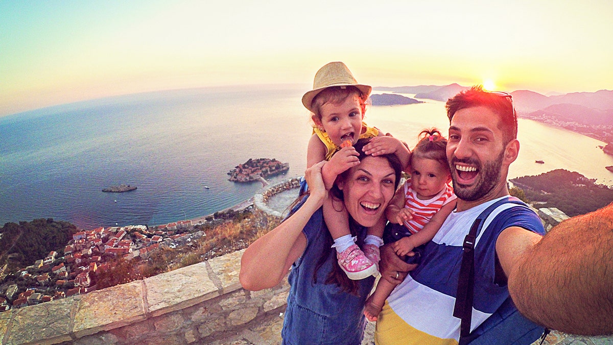 A family enjoys a vacation with a sunset in the background.